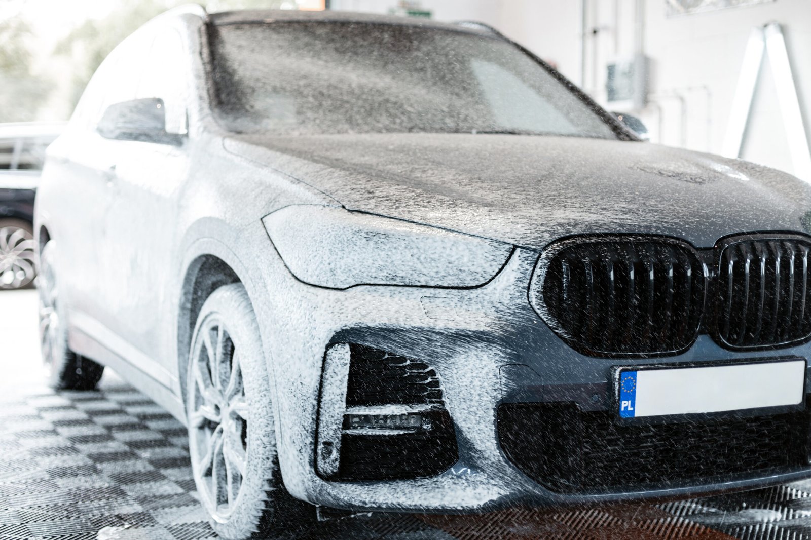 modern-car-with-white-foam-is-washed-car-wash-car-care-detailing-1-scaled-1.jpg